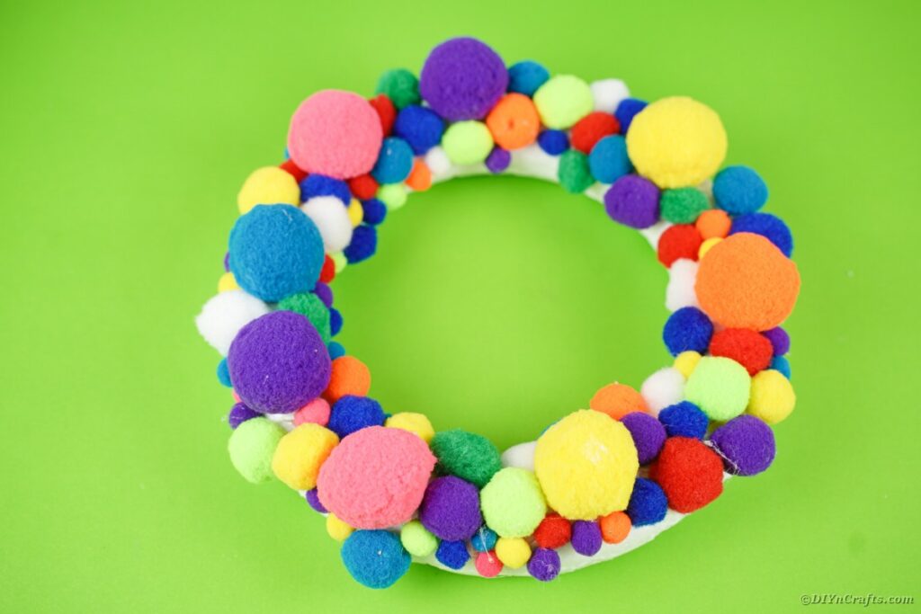 Wreath form covered in pom poms