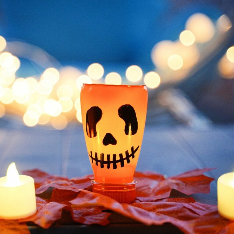 Pumpkin lantern on leaves with candles