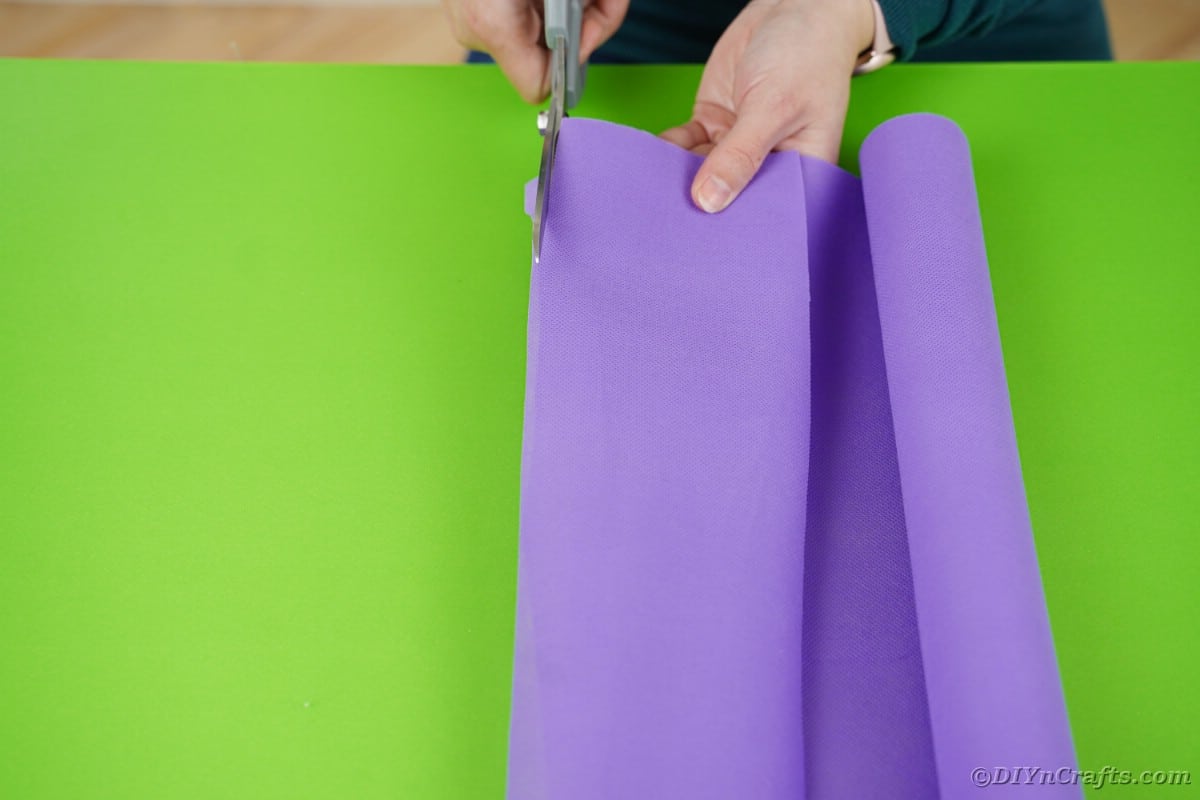 Cutting purple fabric
