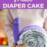 Woman holding snail diaper cake