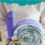 Woman holding snail diaper cake