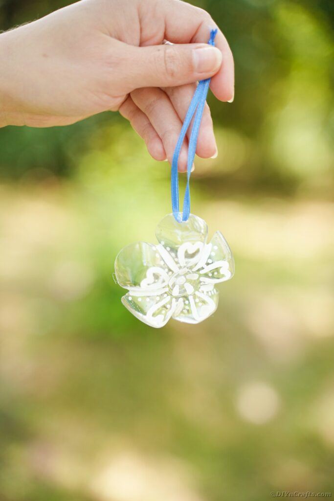 Hand holding snowflake ornament
