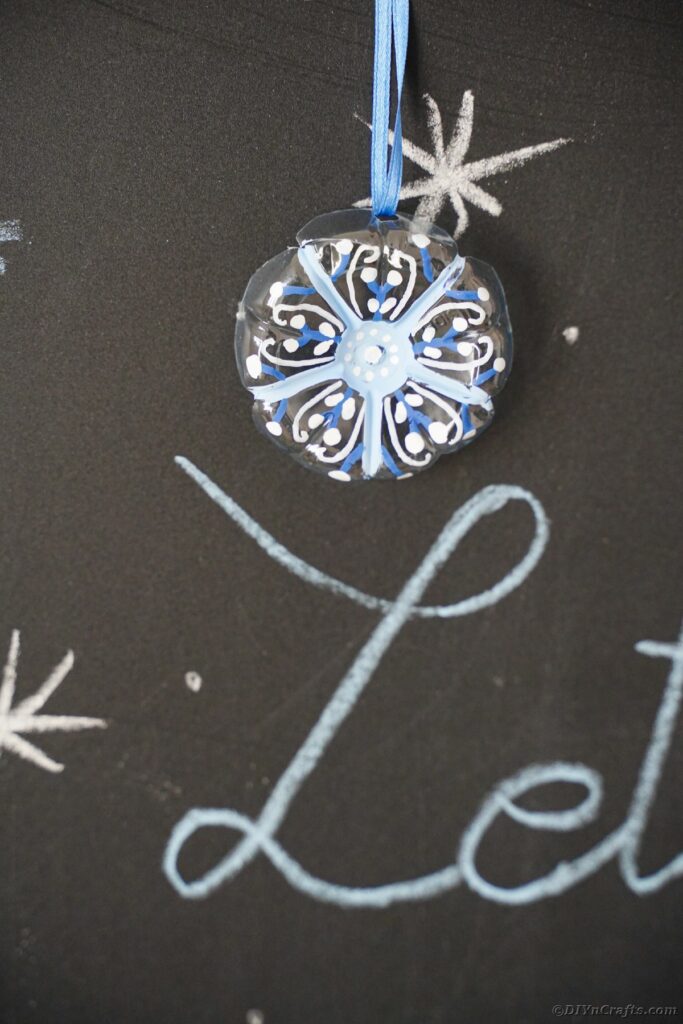 Snowflake ornaments on chalkboard