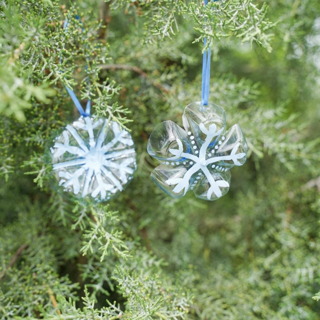 Snowflake ornaments in evergreen tree
