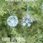 Snowflake ornaments in evergreen tree