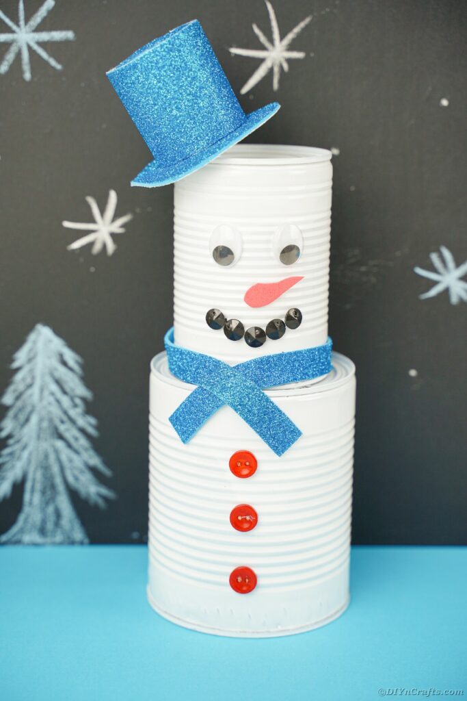 Tin can snowman by chalkboard