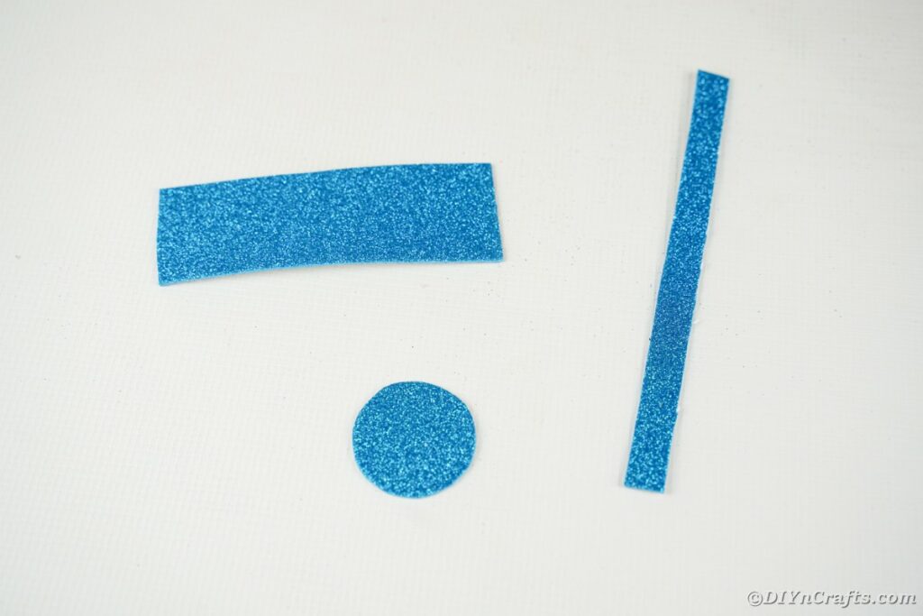 Blaue Schaumstoffpapierstücke auf weißem Tisch