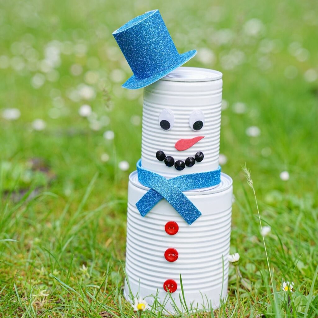 Tin can snowman on grass