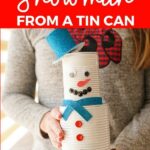 Woman holding tin can snowman