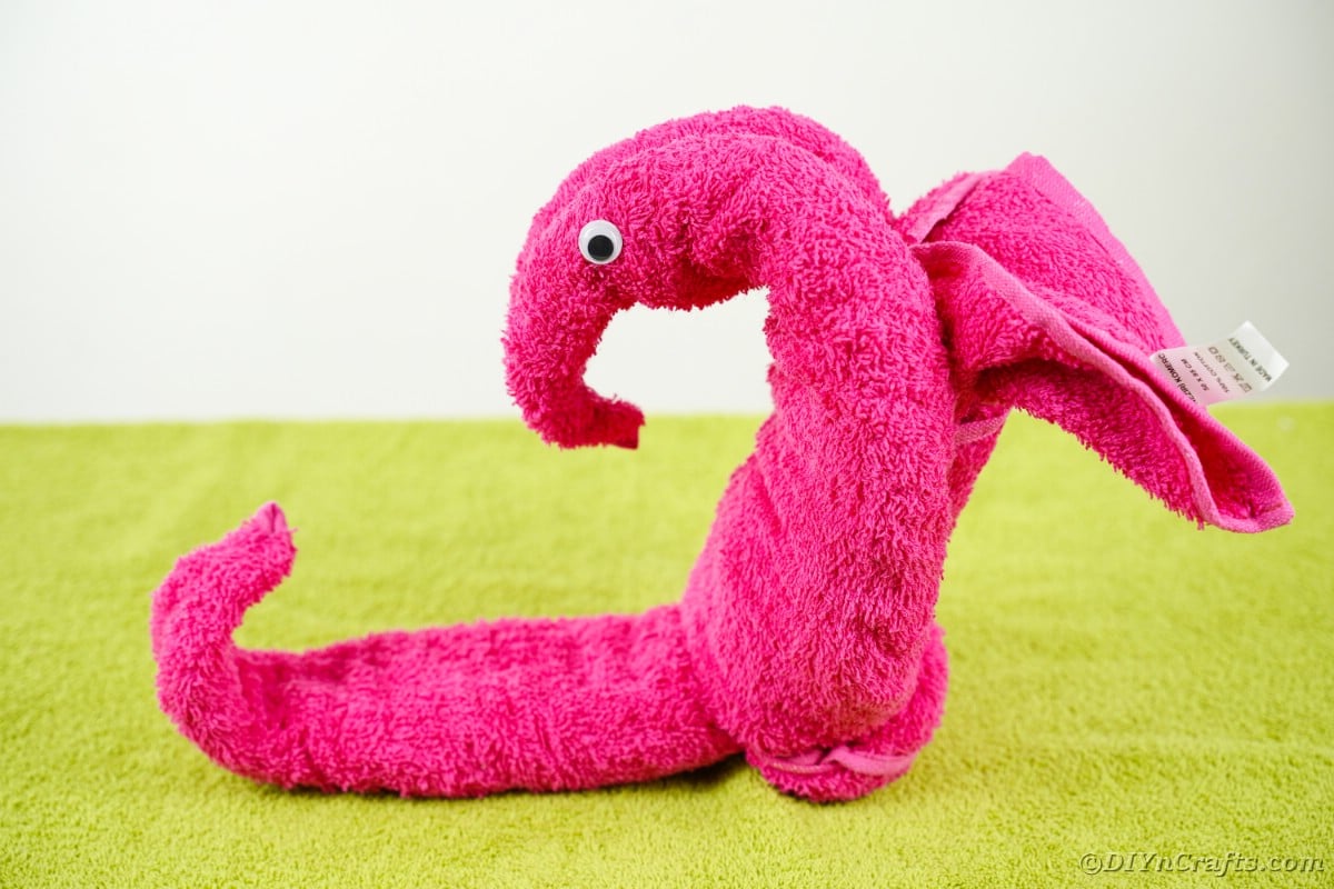 Pink towel seahorse on green table