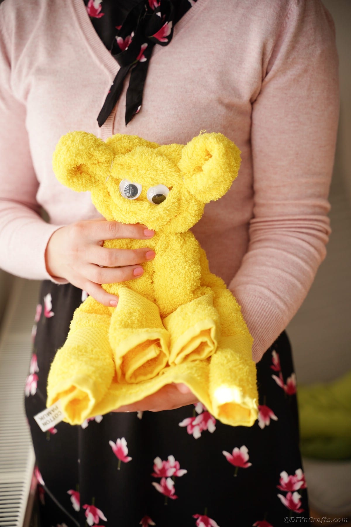Woman holding yellow bear towel