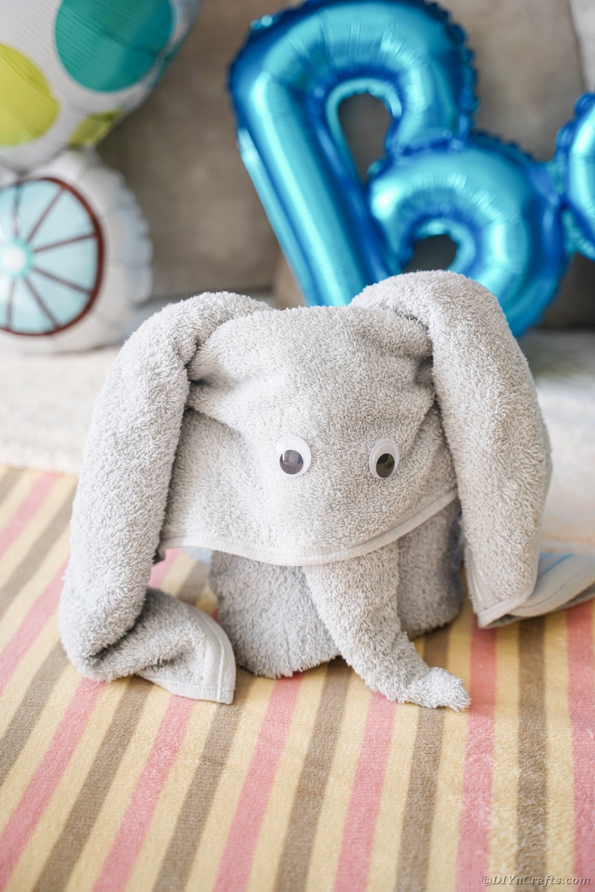 Grey towel elephant on bed