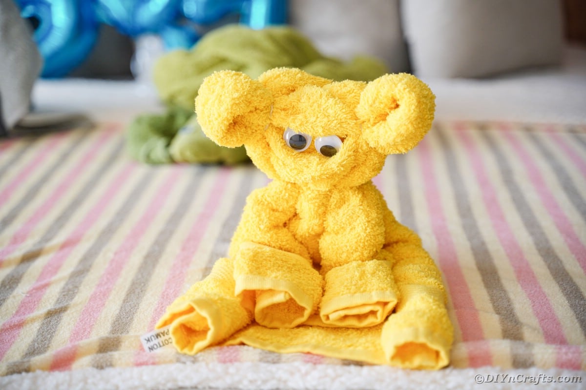 Yellow towel bear on bed