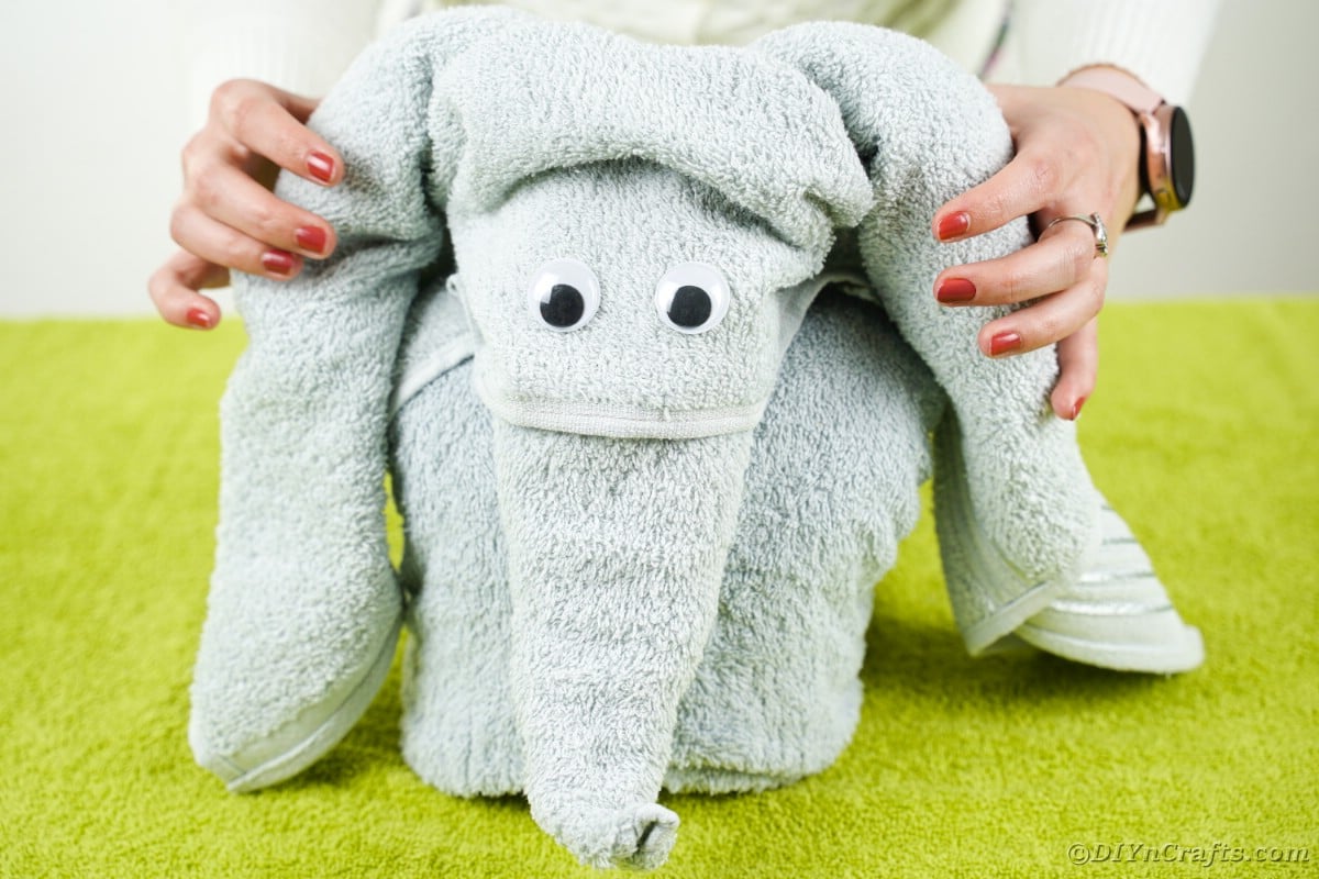 Gray towel elephant on green towel