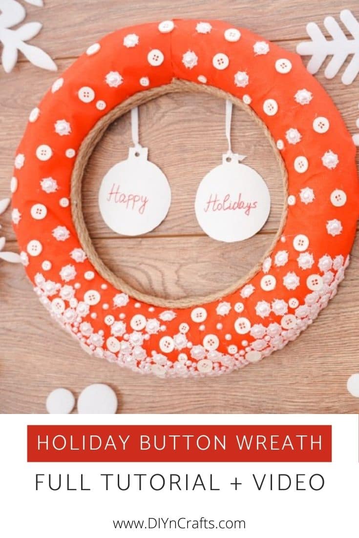 Red wreath bade from buttons on a wooden backdrop