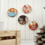Wood slices with fall images hanging on white shiplap wall