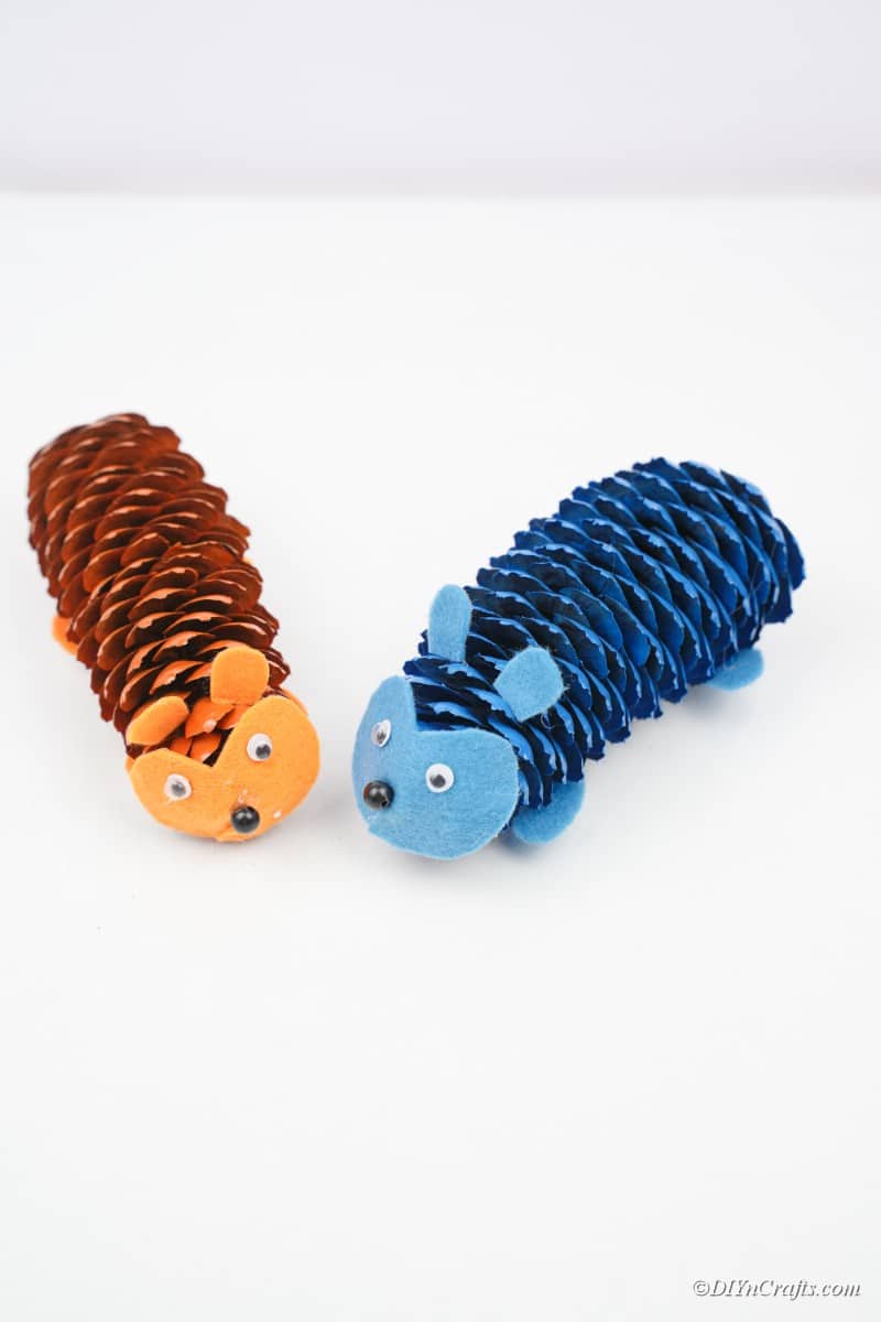 Blue and orange pinecone hedgehogs on white table