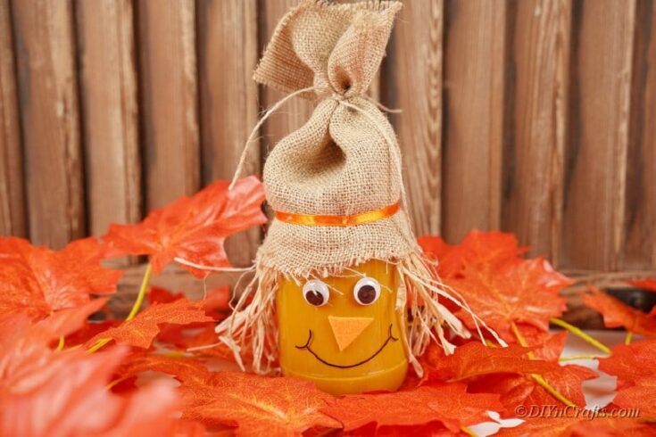 Scarecrow jar craft on decorative spread