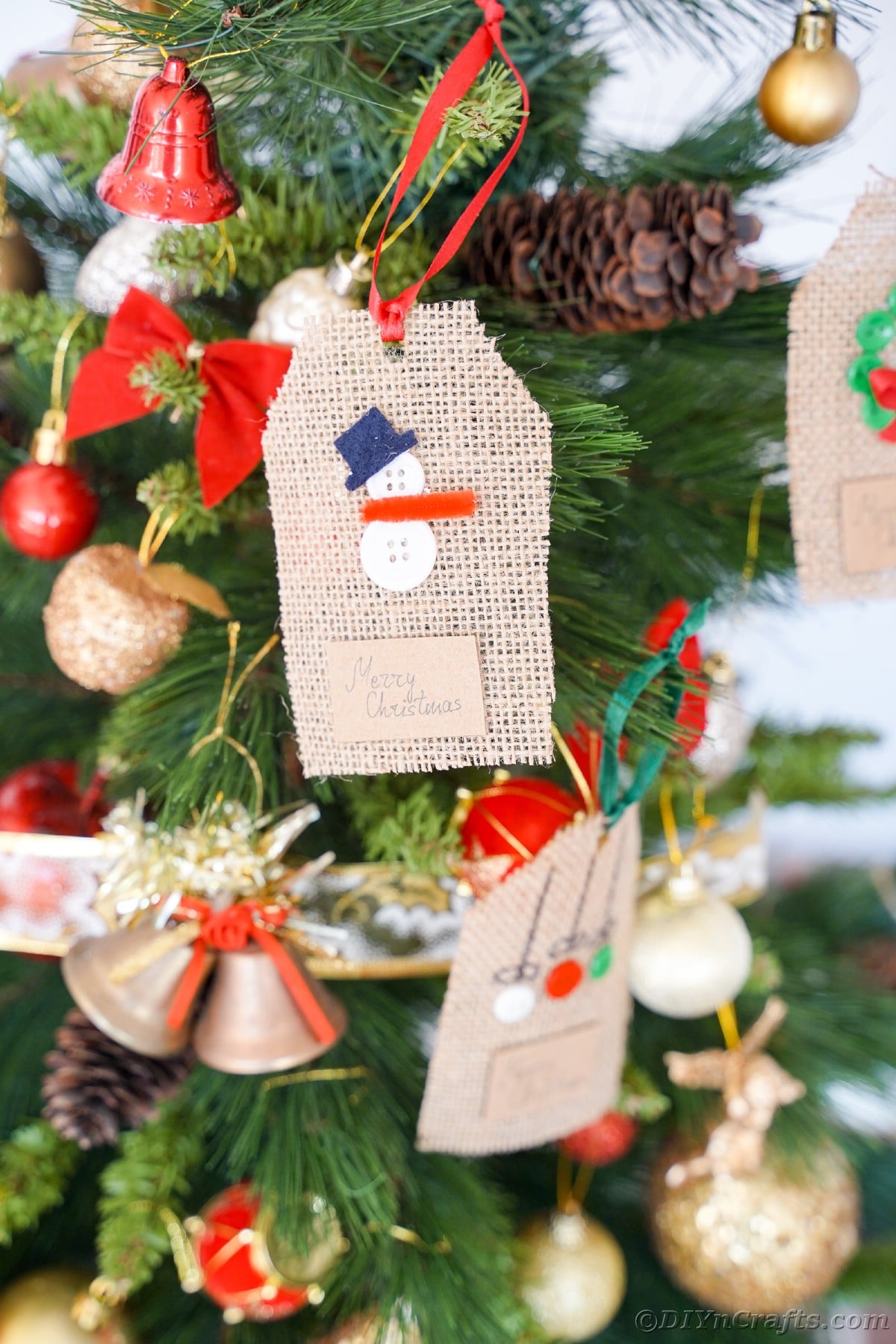 snowman gift tag hanging on Christmas tree