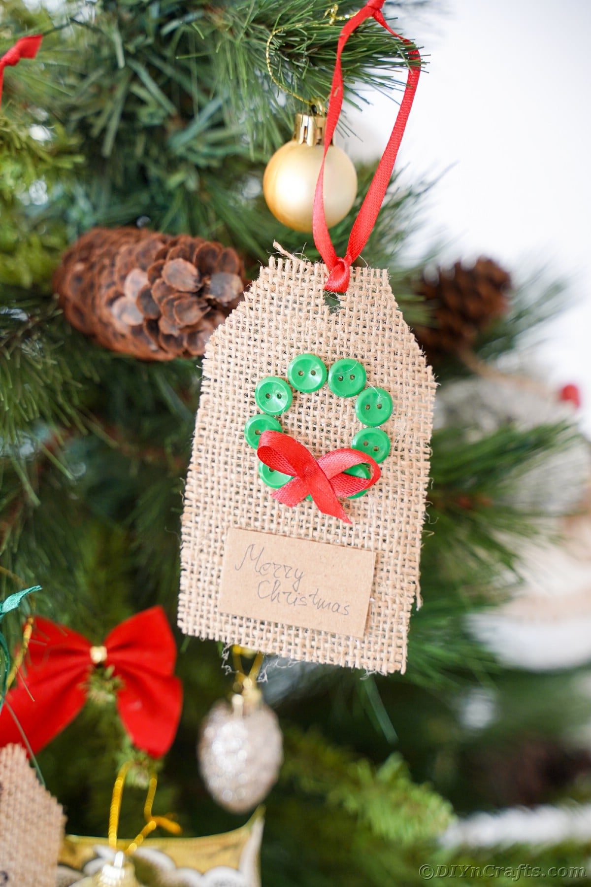 wreath gift tag hanging on Christmas tree