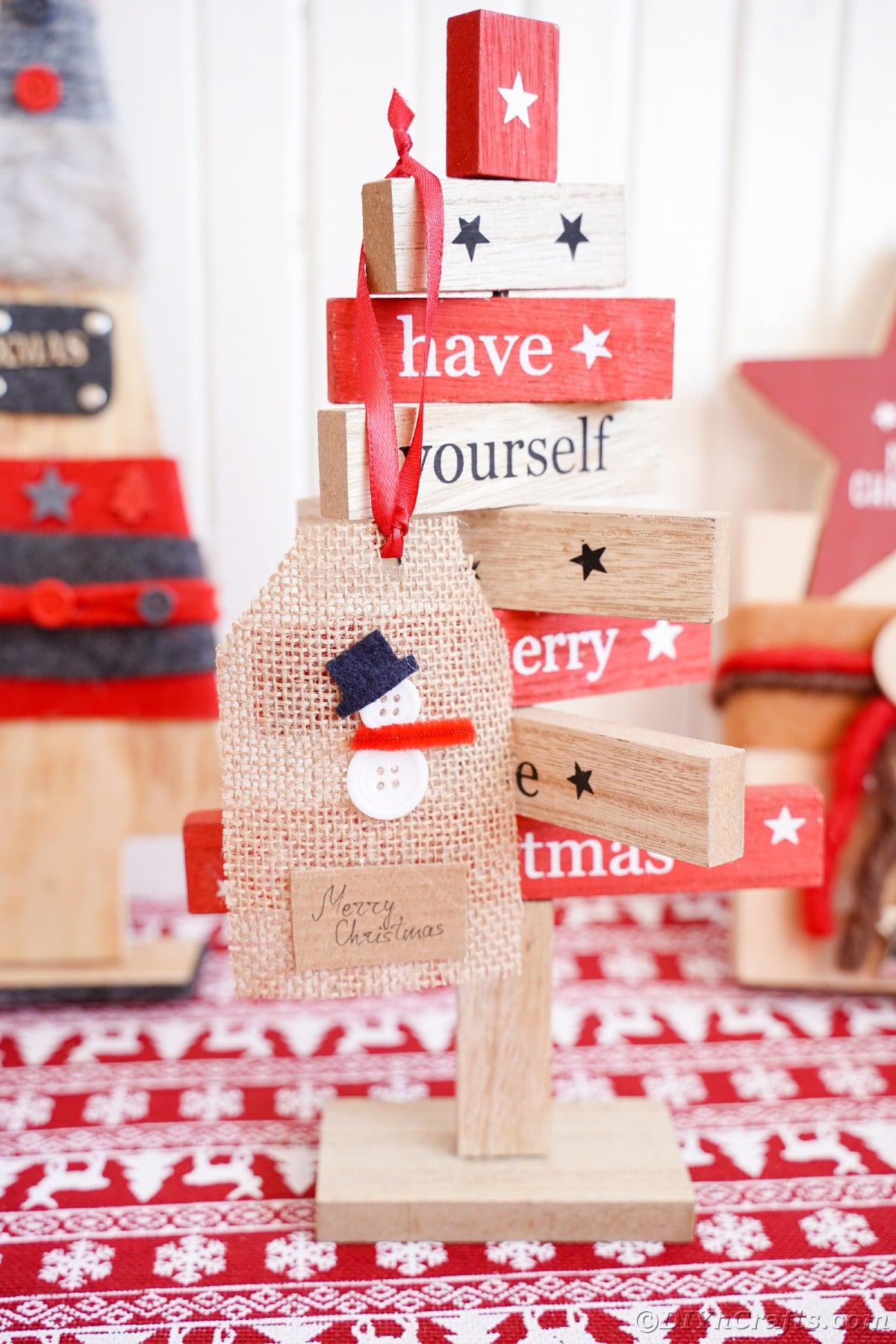 snowman burlap gift tag on holiday decor with red and white table
