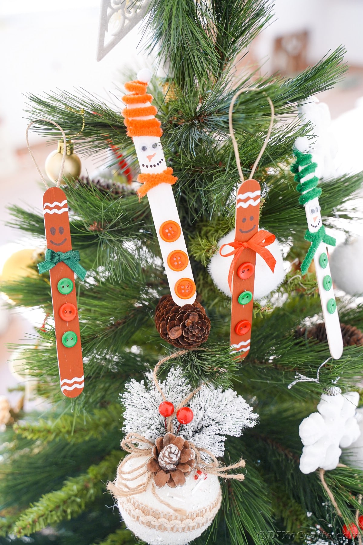craft stick ornaments hanging on Christmas tree