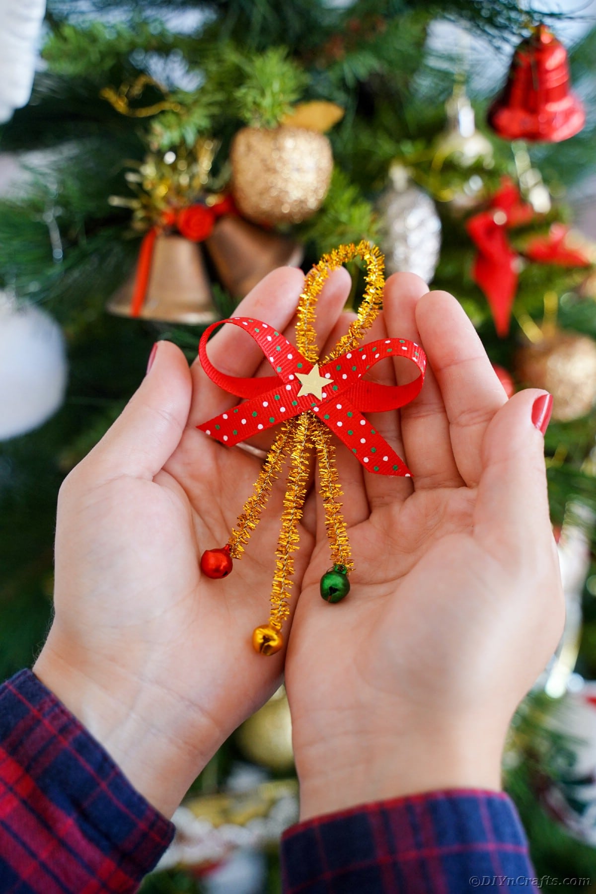 Woman holding pipe cleaner ornament