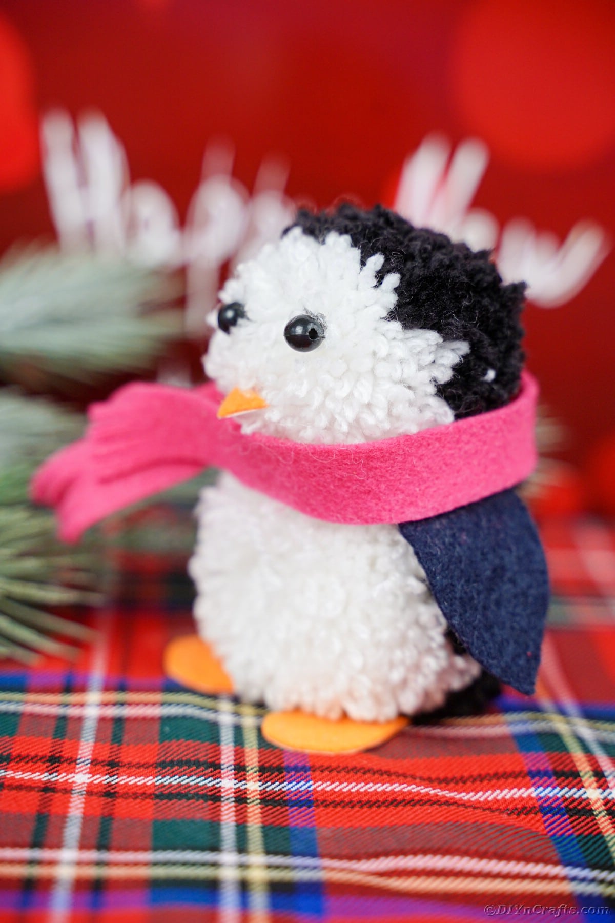 Pom pom penguin on flannel