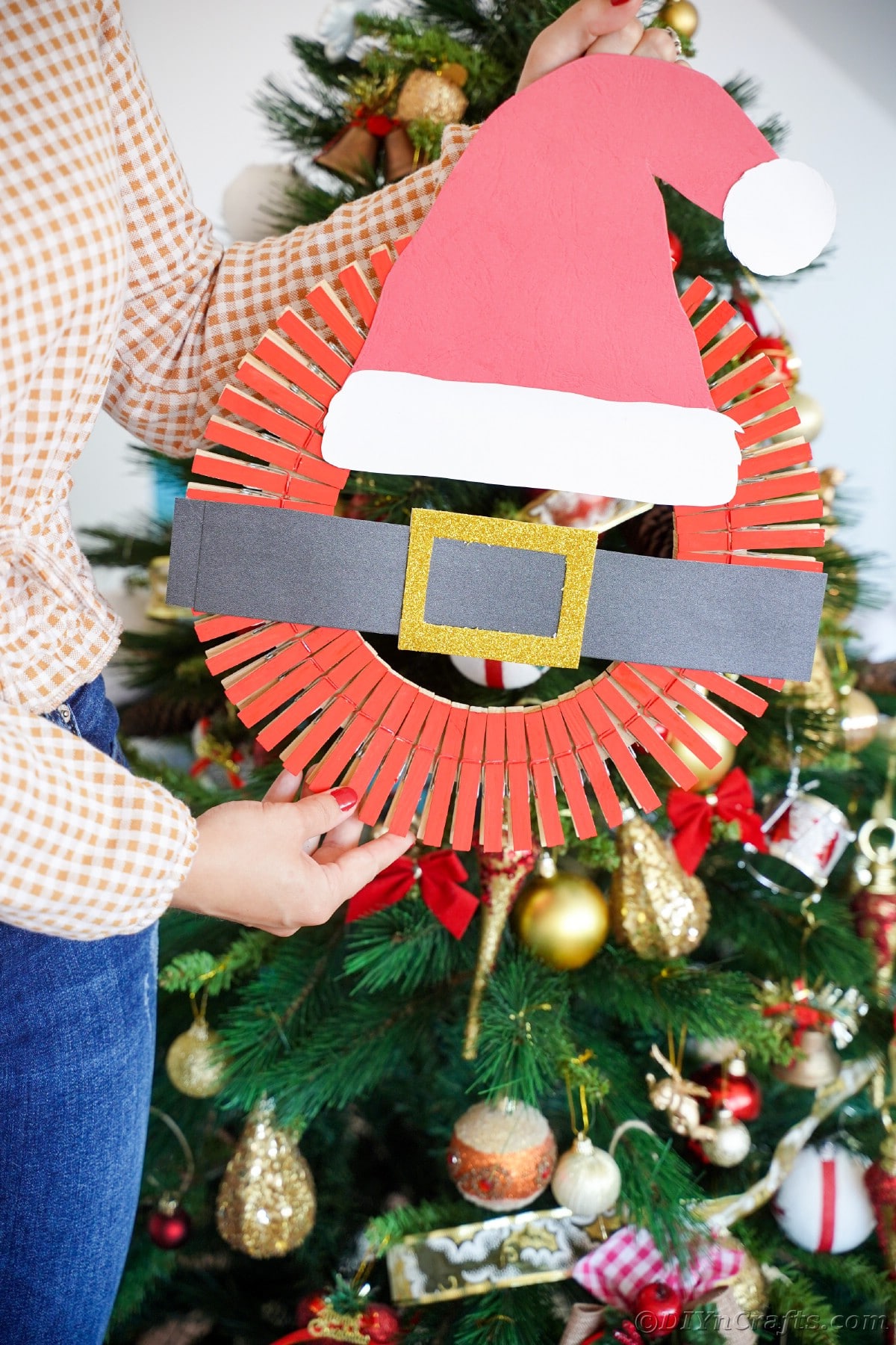 woman holding santa hat wreath
