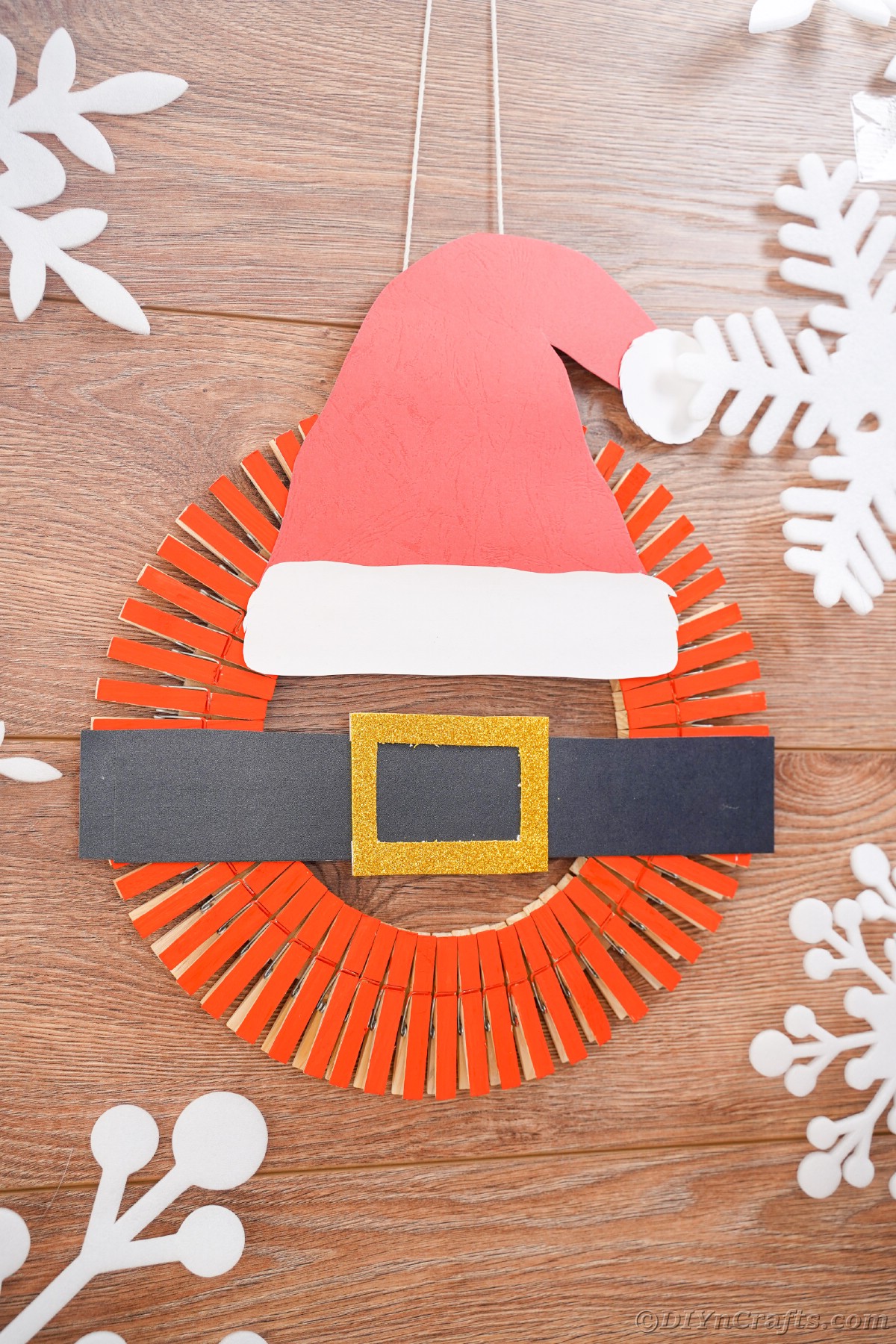Wood surface behind santa belt and hat wreath