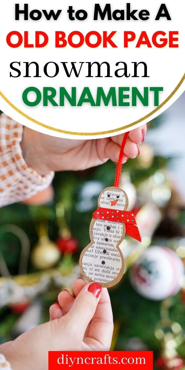 Woman holding paper snowman ornament