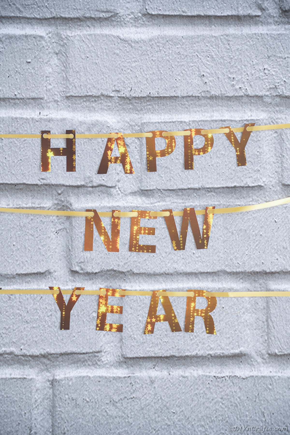 Happy New Year banner against brick wall