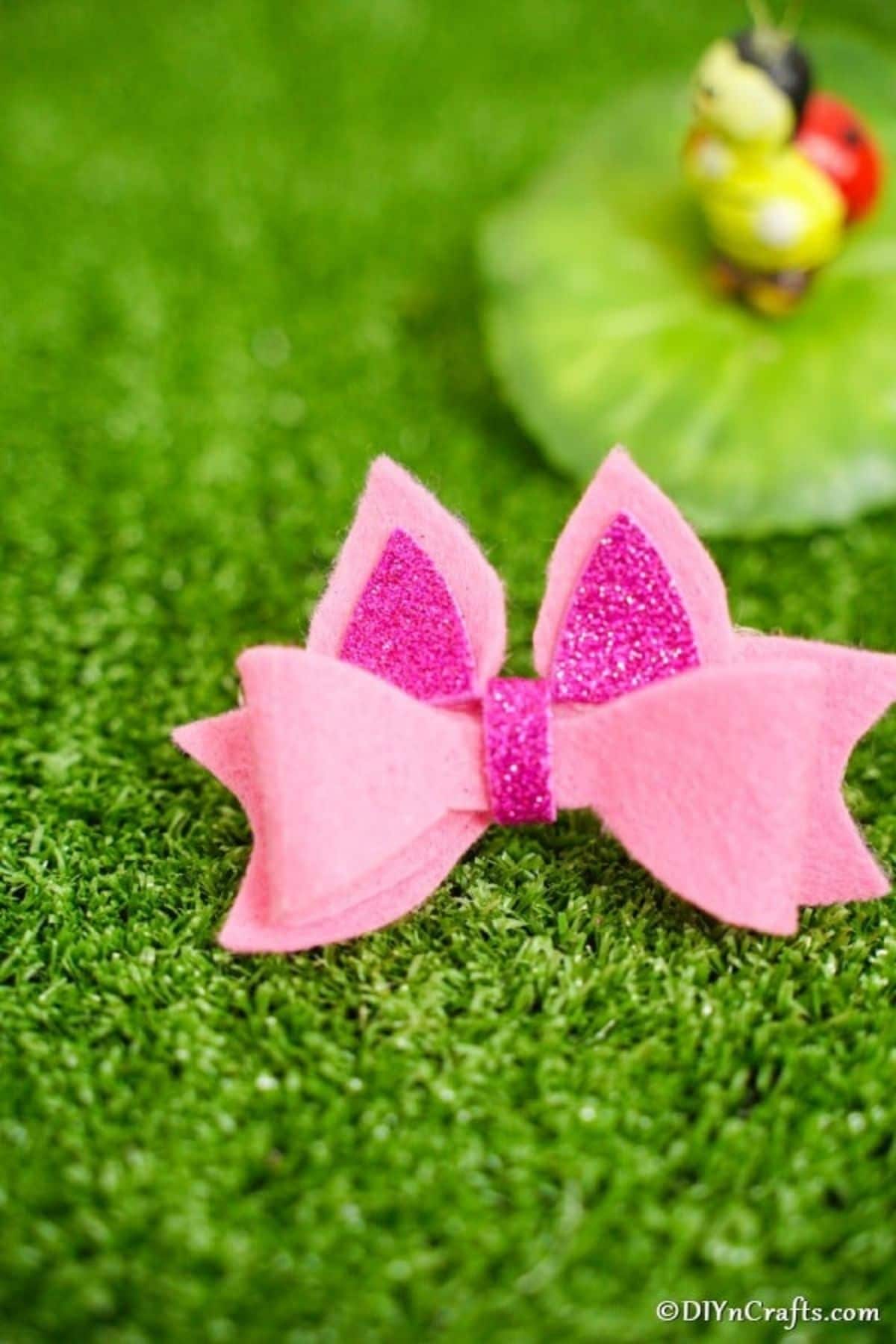Pink bow on grass