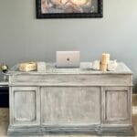 Distressed desk by wall