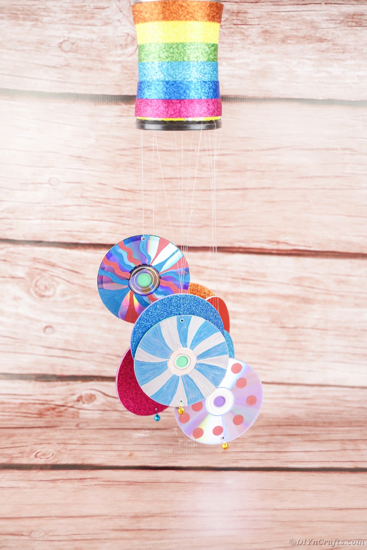 Wind chime hanging by wooden wall