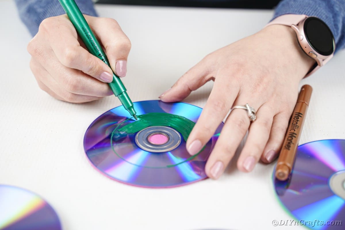 Woman painting CD green