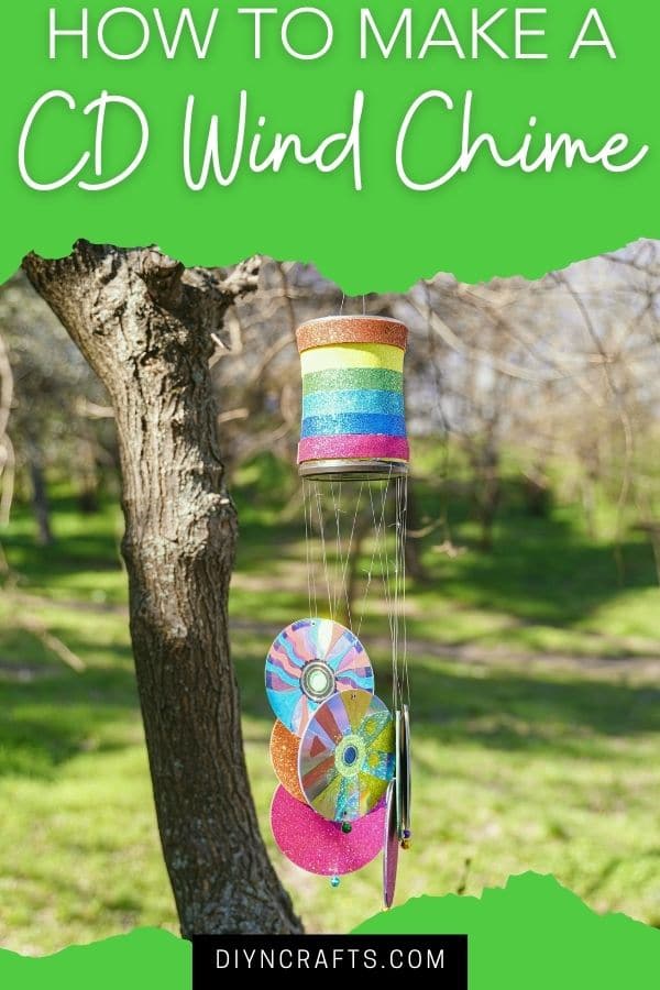 Wind chime outside with green overly and white text that says DIY wind chime