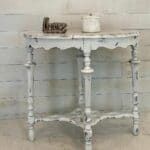 White and grey distressed end table with love sign and candle on top