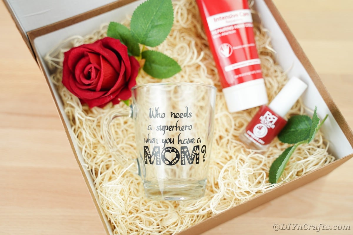 Gift box with glass mug and flowers