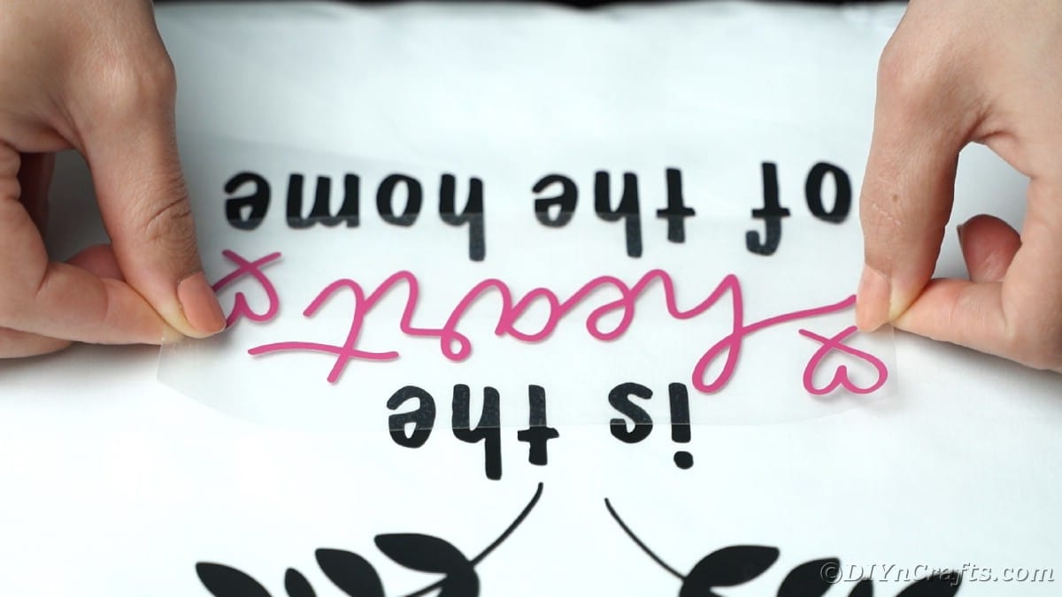 Adding pink vinyl words on apron