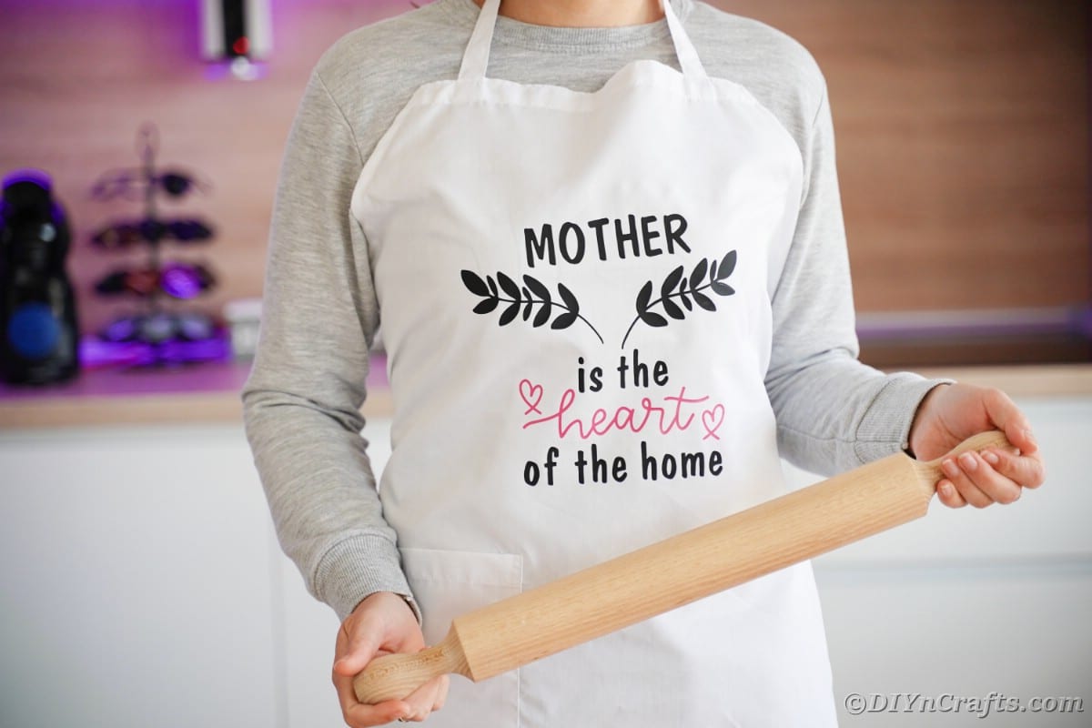 Woman in apron holding rolling pin