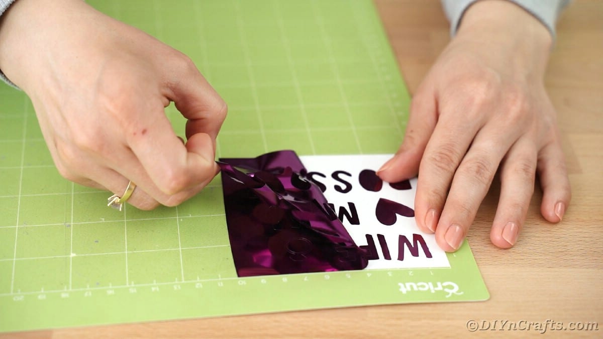 Peeling excess foil off message on Cricut mat