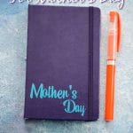 Blue journal with light blue mother's day printed on bottom by orange marker