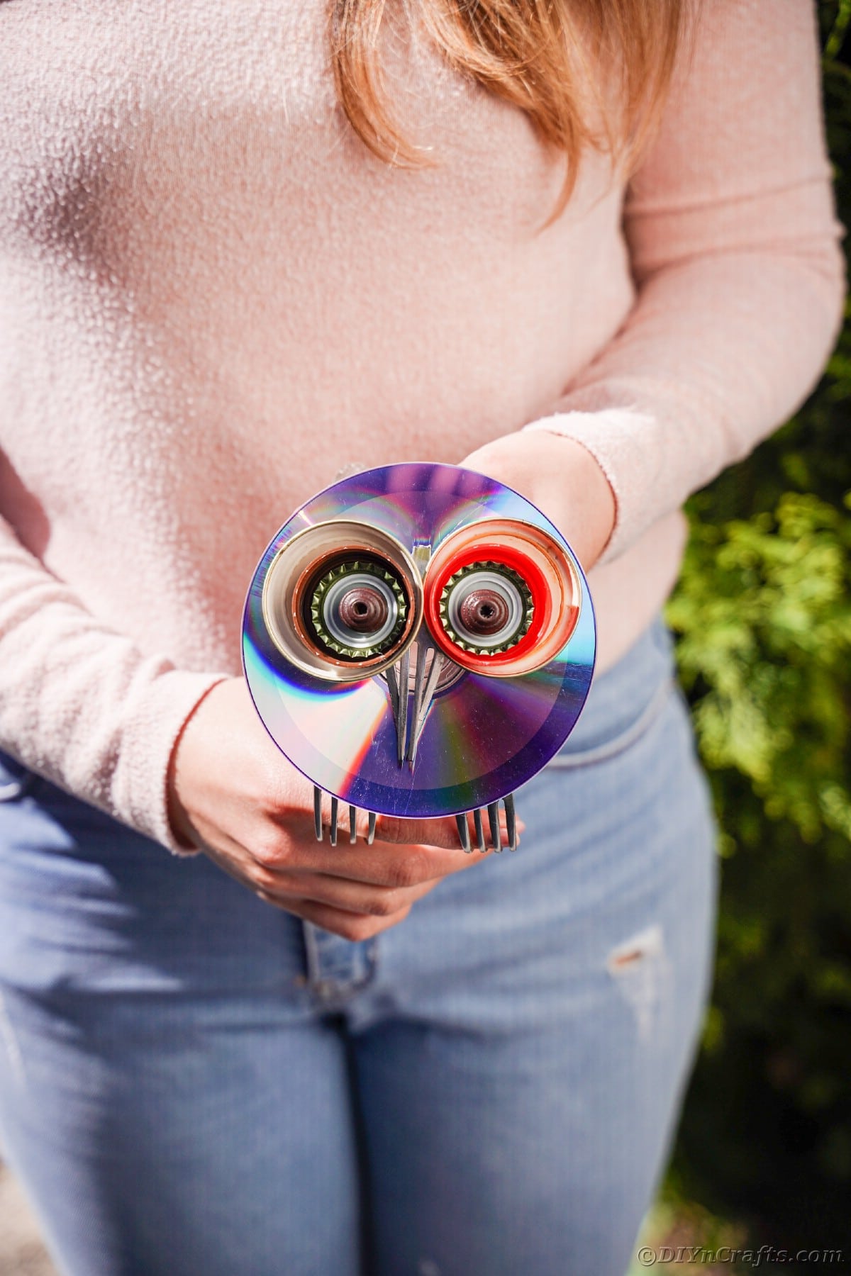 Woman holding CD owl in front of her