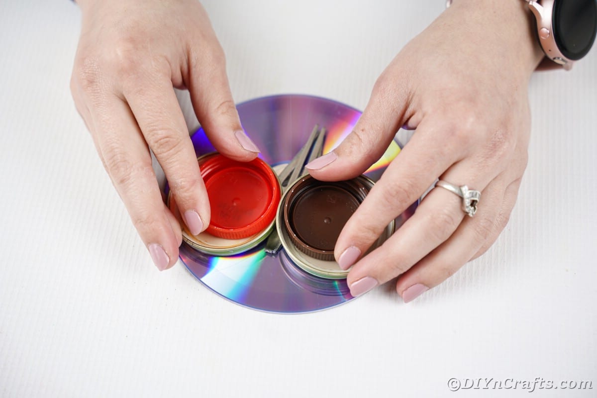 Gluing smaller lids into large lids on CD