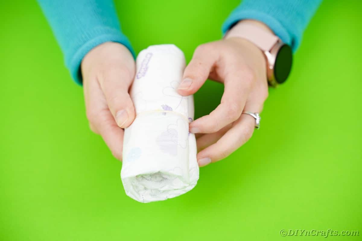 Woman holding rolled diaper