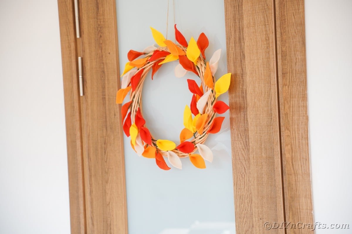 Wood and glass door with fall wreath hanging