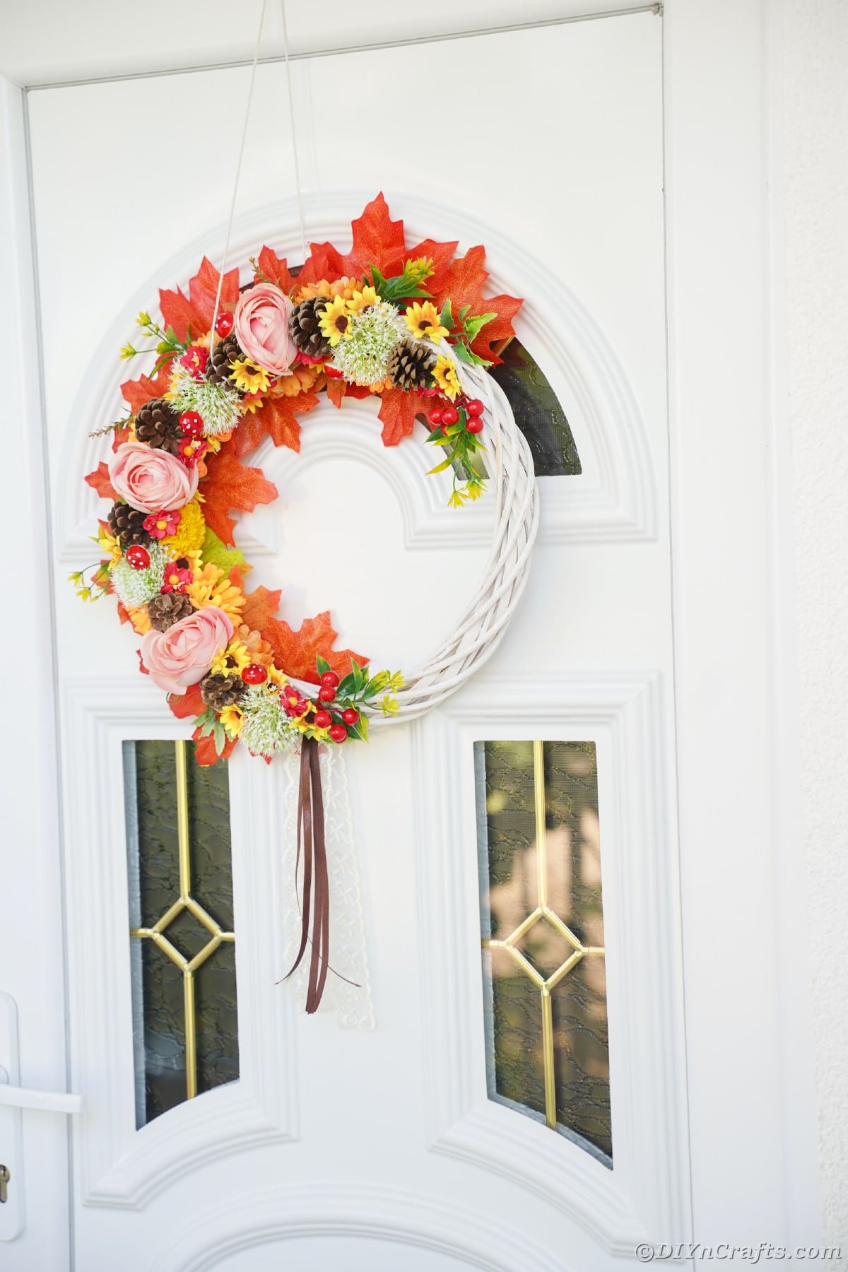 Fall colored wreath on white and glass door