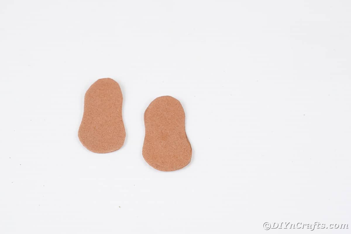 Two foot shaped brown pieces on white table
