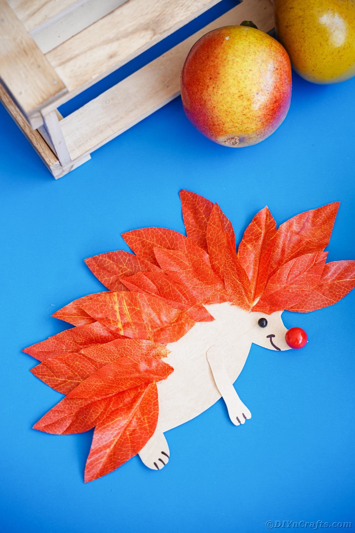 Fake leaf hedgehog on blue paper